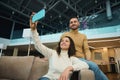 Beautiful young loving couple of newlyweds on their honeymoon trip making selfie on a smartphone while relaxing together in the Royalty Free Stock Photo