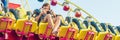 Beautiful, young man having fun at an amusement park BANNER, long format Royalty Free Stock Photo