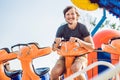 Beautiful, young man having fun at an amusement park Royalty Free Stock Photo