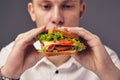 Young man looking at a fresh burger Royalty Free Stock Photo