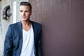 Beautiful young man outdoors against a wall Royalty Free Stock Photo