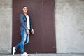 Beautiful young man outdoors against a wall Royalty Free Stock Photo