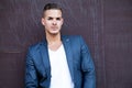 Beautiful young man outdoors against a wall Royalty Free Stock Photo
