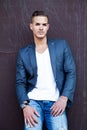 Beautiful young man outdoors against a wall Royalty Free Stock Photo