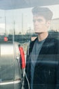 Beautiful young man posing in a phone booth