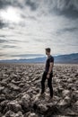 beautiful landscape of Devil's golf course in death valley with young manr walking at sunset Royalty Free Stock Photo