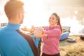 Beautiful young man and woman exercising, stretching in the early morning mist on the lake or river banks Royalty Free Stock Photo