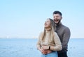 Beautiful young married couple posing on the beach. Man and woman laughing and hugging Royalty Free Stock Photo