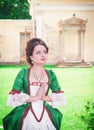 Beautiful young medieval woman in green dress praying Royalty Free Stock Photo