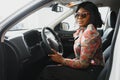 Happy african woman driving a new car Royalty Free Stock Photo