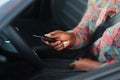 Beautiful young mixed race black African American woman driving car and show holding the key Royalty Free Stock Photo