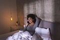 Woman lying in bed and having a phone conversation Royalty Free Stock Photo