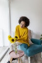 Woman putting flowers into vase Royalty Free Stock Photo