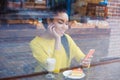 Beautiful young mixed race woman seen through the window of bakery Royalty Free Stock Photo