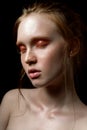 Beautiful young model with glossy eyeshadow and wet skin. Summer makeup trends