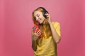 Beautiful young modern girl in headphones enjoying listening to music using mobile phone app for melomaniac, music lover Royalty Free Stock Photo