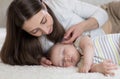 Beautiful young mom and baby sleeping in bed at home Royalty Free Stock Photo