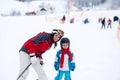 Beautiful young mom and her toddler boy, skiing in the mountains Royalty Free Stock Photo