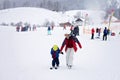 Beautiful young mom and her toddler boy, skiing in the mountains Royalty Free Stock Photo