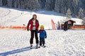 Beautiful young mom and her toddler boy, skiing in the mountains Royalty Free Stock Photo