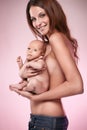 Beautiful young mom holding a baby (retouched) Royalty Free Stock Photo