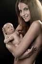 Beautiful young mom holding a baby (retouched) Royalty Free Stock Photo