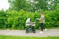 young mom walks with a stroller