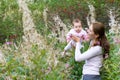 Beautiful young mother with a baby girl in flower field Royalty Free Stock Photo