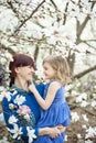 beautiful young mother with baby girl in her arms. The concept of a happy family, motherhood. mother with her dauther with flowers Royalty Free Stock Photo