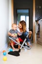 Young mother with a baby boy doing housework. Royalty Free Stock Photo