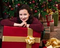 Naughty woman leans on a huge box with a New Year gift Royalty Free Stock Photo