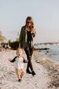 Beautiful Young Mother and Cute Little Boy Son Walking and Enjoying the Nice Outdoor Weather on the Sandy Beach next to the Ocean Royalty Free Stock Photo