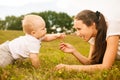 Beautiful young mother giving flower to her baby Royalty Free Stock Photo