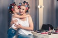 Beautiful young mother and her daughter with hair curlers Royalty Free Stock Photo