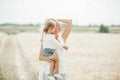 Beautiful young mother and her little daughter at the wheat field on a sunny day Royalty Free Stock Photo