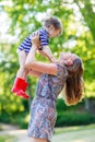 Beautiful young mother holding her happy little kid girl in arms Royalty Free Stock Photo