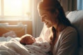 Beautiful young mother holding her newborn in maternity ward after delivery. New mom welcoming her first child into the world. Royalty Free Stock Photo