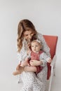 A beautiful young mother holds her adorable daughter in her arms, hugging her.A cute little girl looks at the camera mom Royalty Free Stock Photo