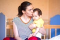 Beautiful young mother kissing and pampering her baby. mixed race kazakh