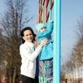 Beautiful young mother playing with her baby on the playground