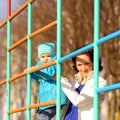 Beautiful young mother playing with her baby on the playground