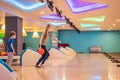 beautiful young mother and son playing bowling with medical masks during COVID-19 coronavirus in bowling club Royalty Free Stock Photo