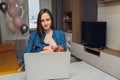 Beautiful young mother working with laptop computer and breastfeeding, holding and nursing her newborn baby at home. Mom Royalty Free Stock Photo
