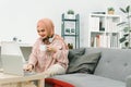 A beautiful young Muslim woman wearing casual clothing is working on a laptop computer while sitting in the living room Royalty Free Stock Photo