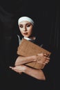 Beautiful young nun in religion black suit holds Bible. Religion concept Royalty Free Stock Photo