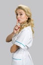 Beautiful young nurse gesturing silence. Royalty Free Stock Photo