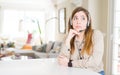 Beautiful young operator woman wearing headset at the office with hand on chin thinking about question, pensive expression Royalty Free Stock Photo