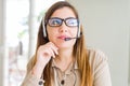 Beautiful young operator woman wearing headset at the office with hand on chin thinking about question, pensive expression Royalty Free Stock Photo