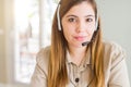 Beautiful young operator woman wearing headset at the office Relaxed with serious expression on face Royalty Free Stock Photo