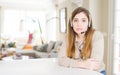Beautiful young operator woman wearing headset at the office with serious expression on face Royalty Free Stock Photo